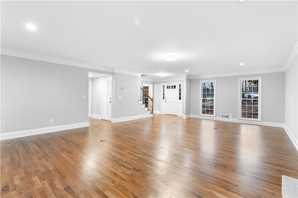 3907 Brinton Mill Road Marietta, GA 30062 - Photo 12 of 61 a view of empty room with wooden floor and fireplace