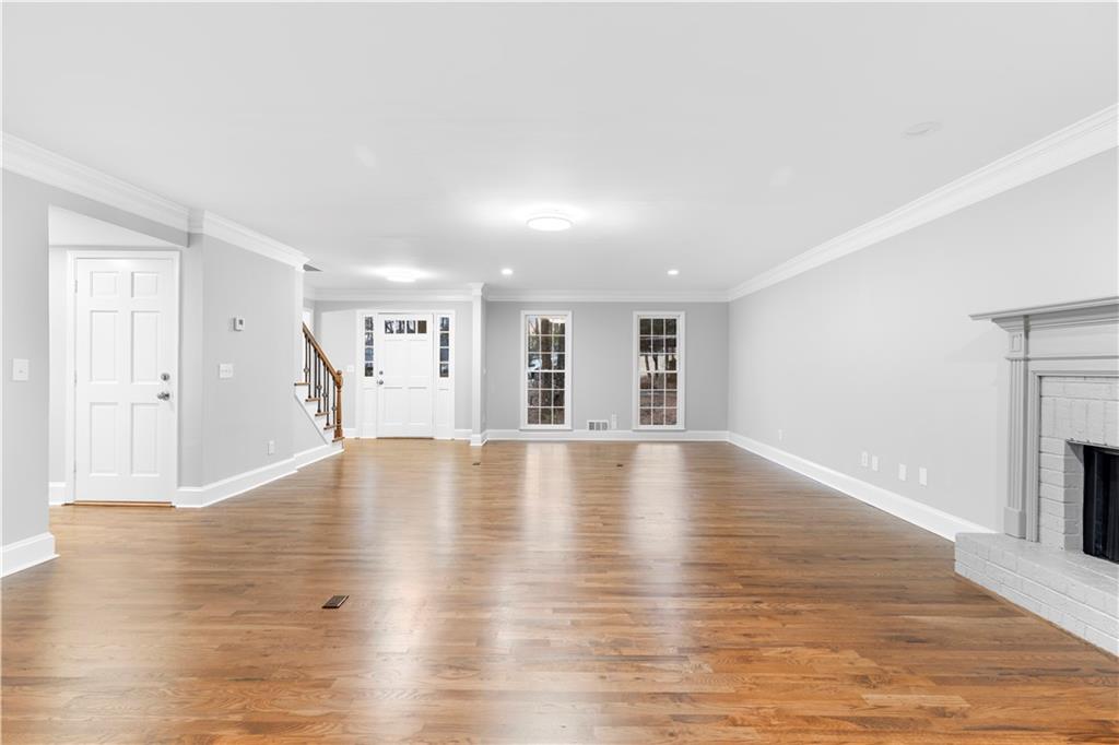 3907 Brinton Mill Road Marietta, GA 30062 - Photo 13 of 61 a view of empty room with wooden floor and fireplace