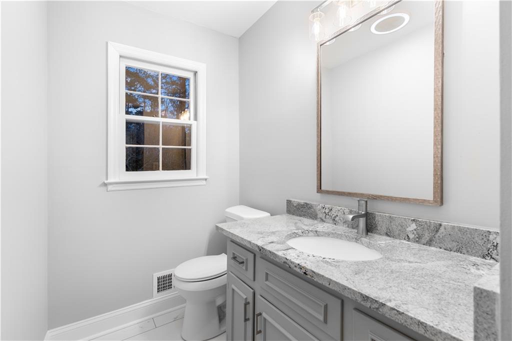 3907 Brinton Mill Road Marietta, GA 30062 - Photo 27 of 61 a bathroom with a granite countertop sink toilet and mirror