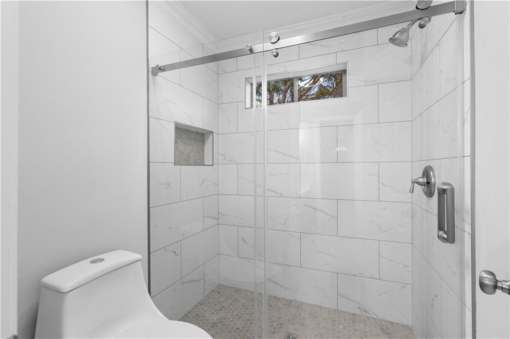 3907 Brinton Mill Road Marietta, GA 30062 - Photo 33 of 61 a bathroom with a toilet and shower
