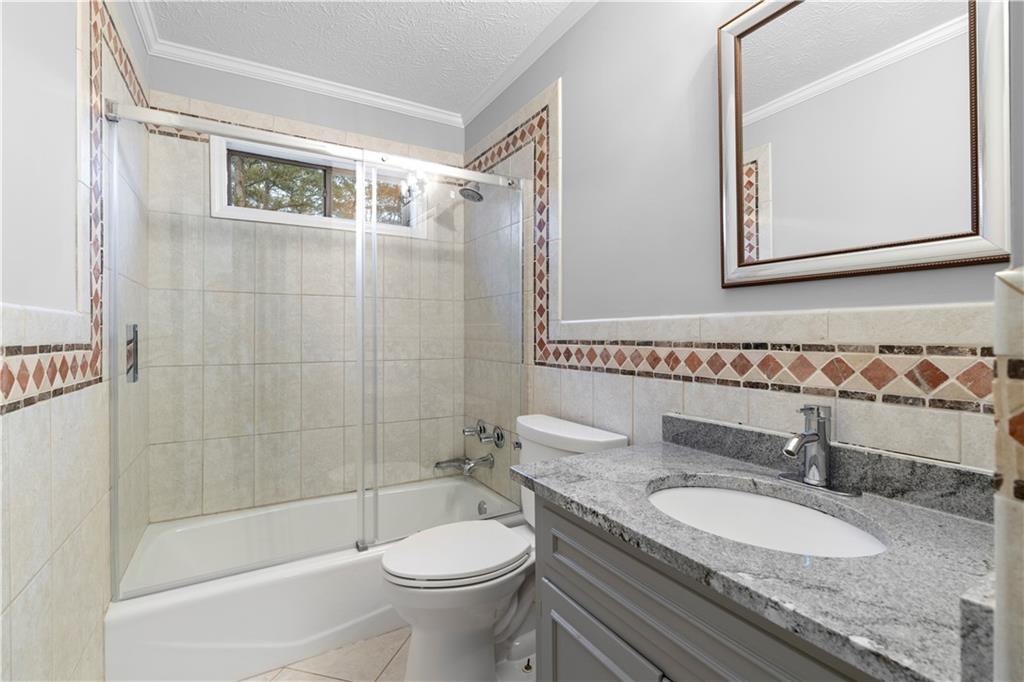 3907 Brinton Mill Road Marietta, GA 30062 - Photo 37 of 61 a bathroom with a granite countertop sink toilet and shower