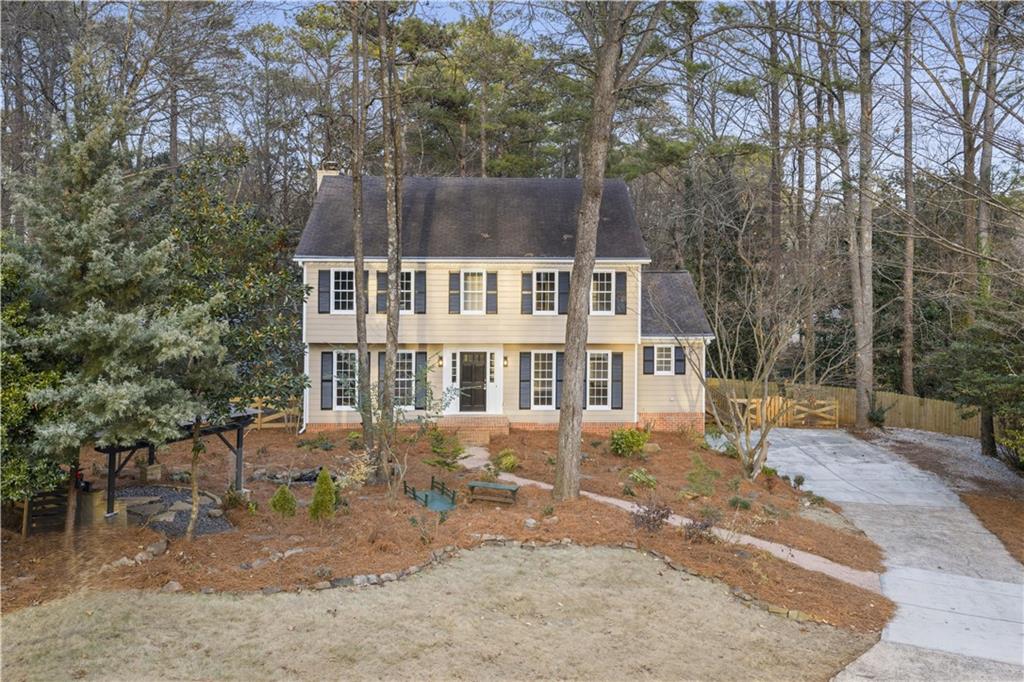 3907 Brinton Mill Road Marietta, GA 30062 - Photo 4 of 61 a view of a big house with a yard and sitting area