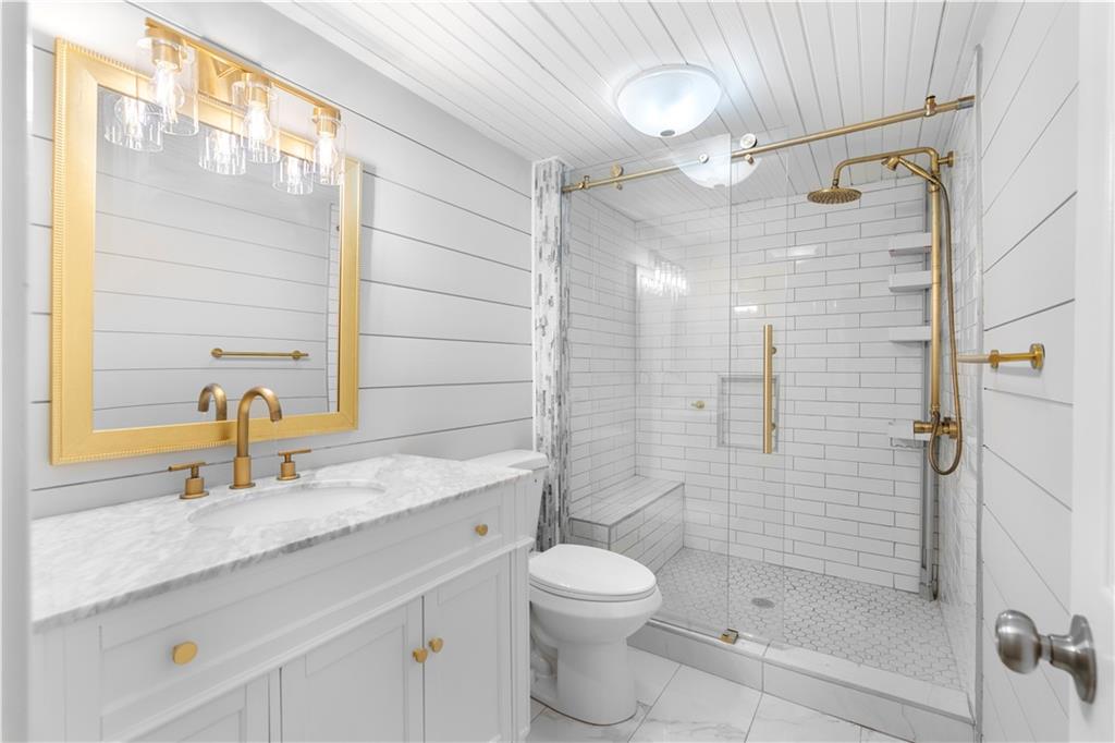 3907 Brinton Mill Road Marietta, GA 30062 - Photo 42 of 61 a bathroom with a granite countertop sink a toilet and shower
