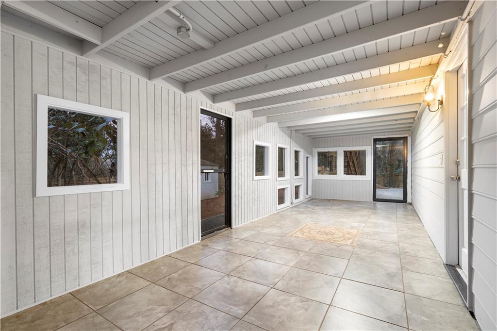 3907 Brinton Mill Road Marietta, GA 30062 - Photo 44 of 61 a view of a porch with furniture and floor to ceiling window