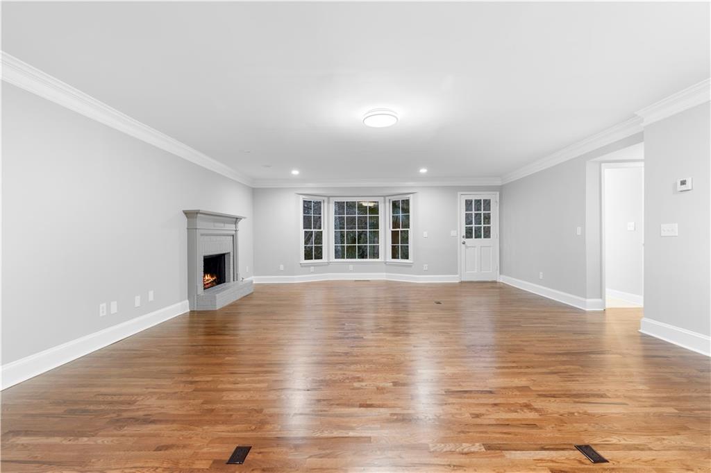 3907 Brinton Mill Road Marietta, GA 30062 - Photo 9 of 61 a view of empty room with wooden floor and fireplace