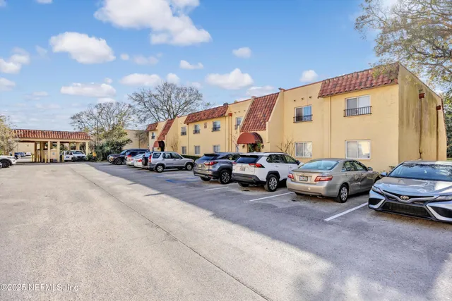 a view of cars parked in front of a house