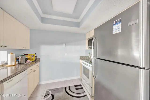 a kitchen with a refrigerator and a sink