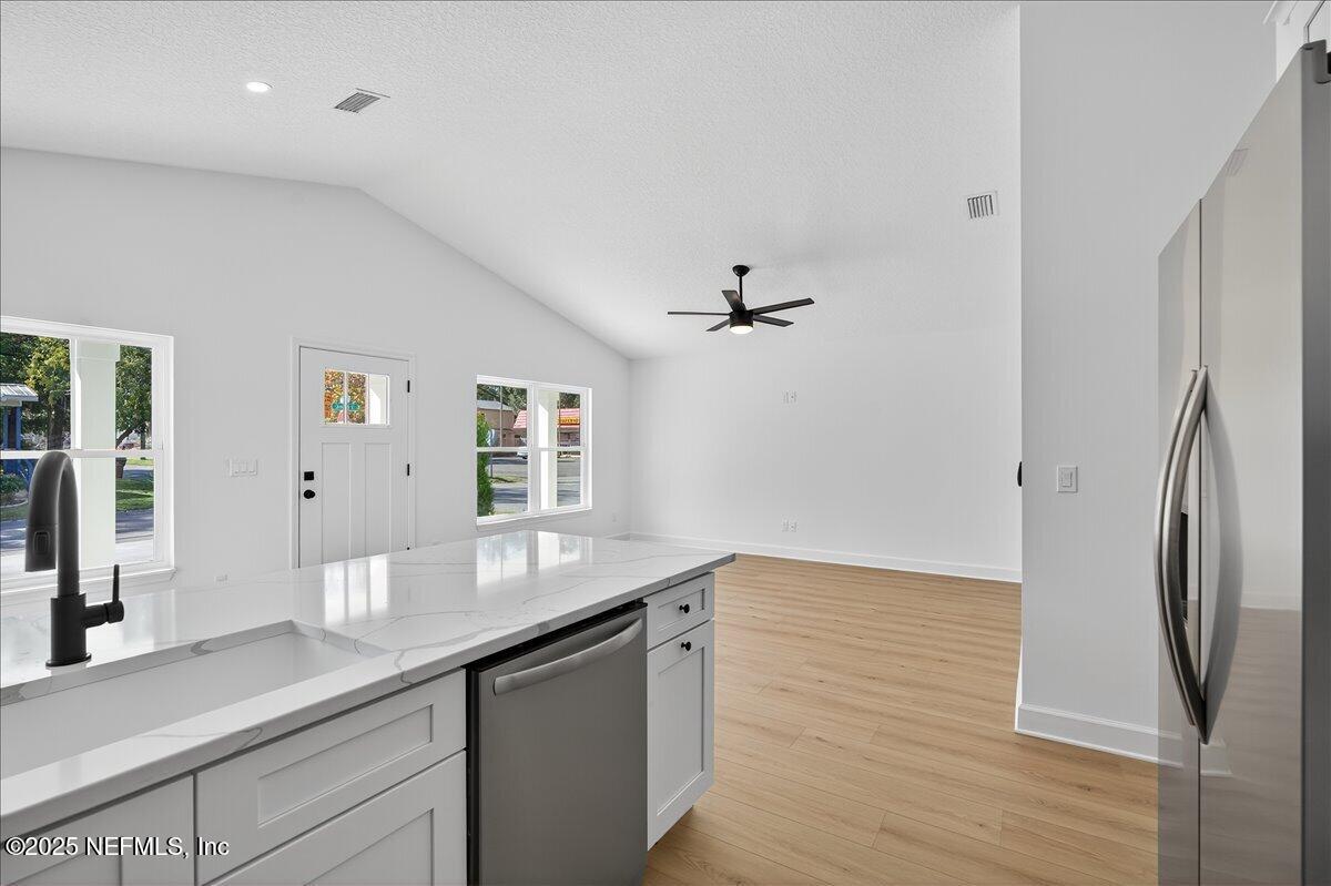 69 Josiah Street St. Augustine, FL 32084 - Photo 14 of 50 a hallway with granite countertop a sink and wooden floor