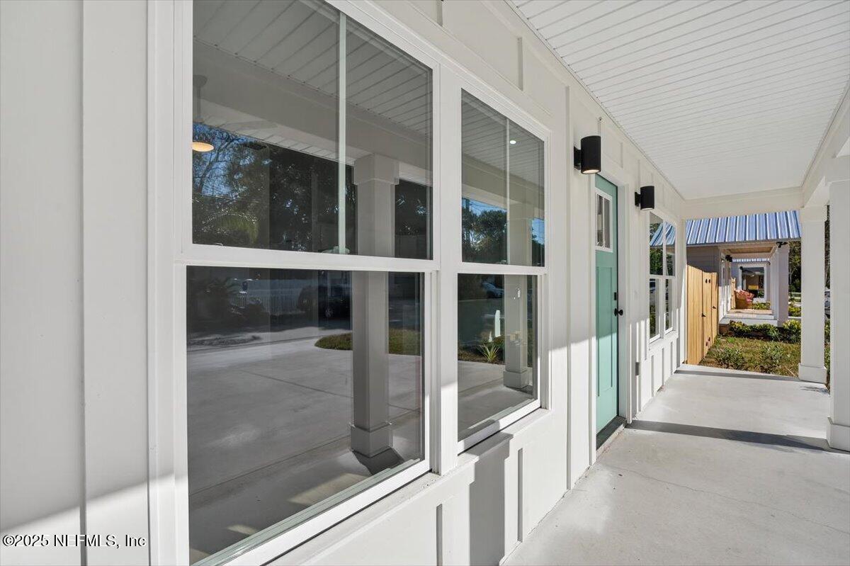 69 Josiah Street St. Augustine, FL 32084 - Photo 7 of 50 a view of a hallway with a glass door and wooden floor