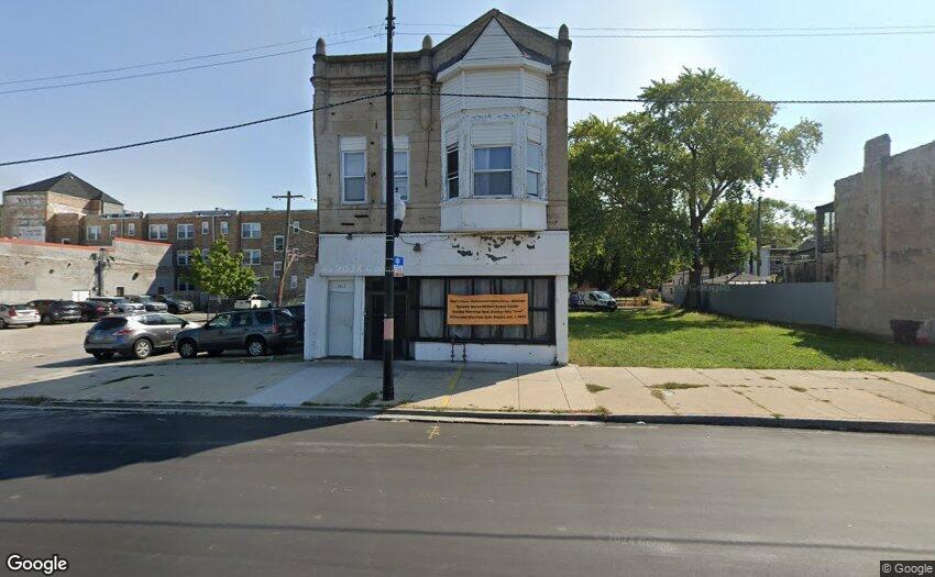 5517 South Halsted Street Chicago, IL 60621 - Photo 2 of 8 a car parked in front of a building