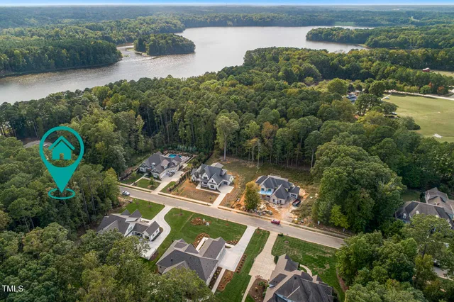 an aerial view of a house with garden space and lake view