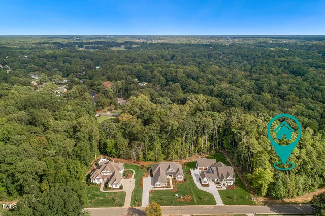 an aerial view of a residential houses with outdoor space