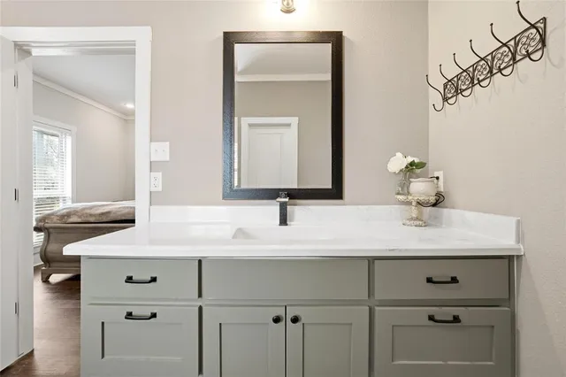 a bathroom with a sink vanity and a mirror