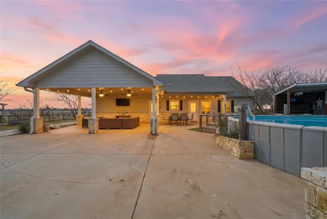 a patio with a table and chairs under an umbrella