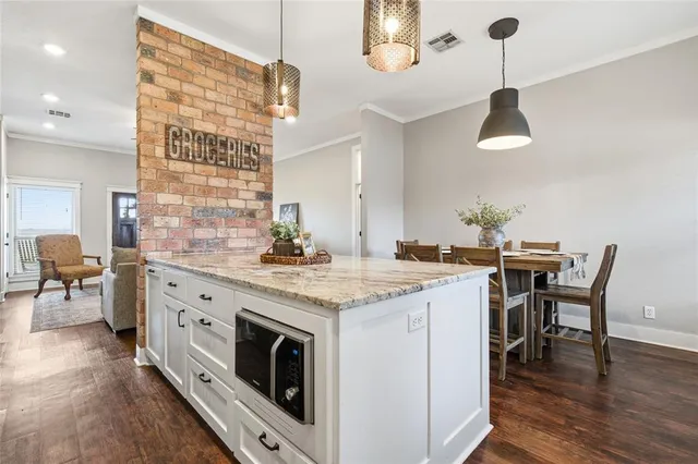 a kitchen with a stove and chairs