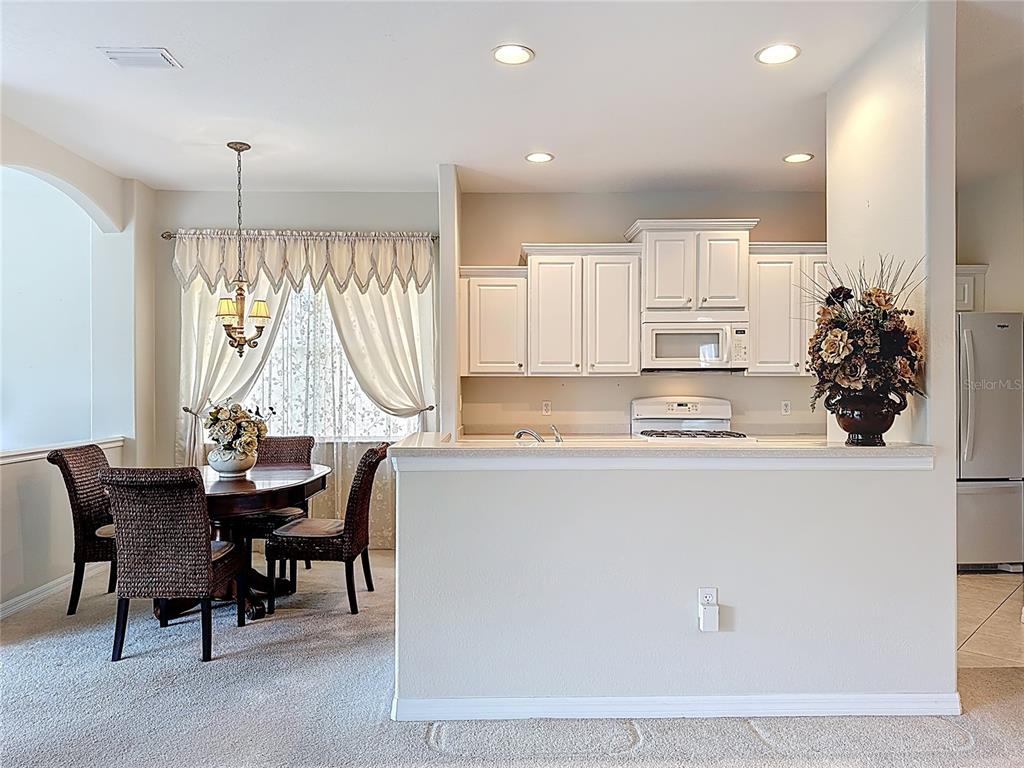 8721 Stone Harbour Loop Bradenton, FL 34212 - Photo 15 of 71 a living room with a table chairs and a dining table