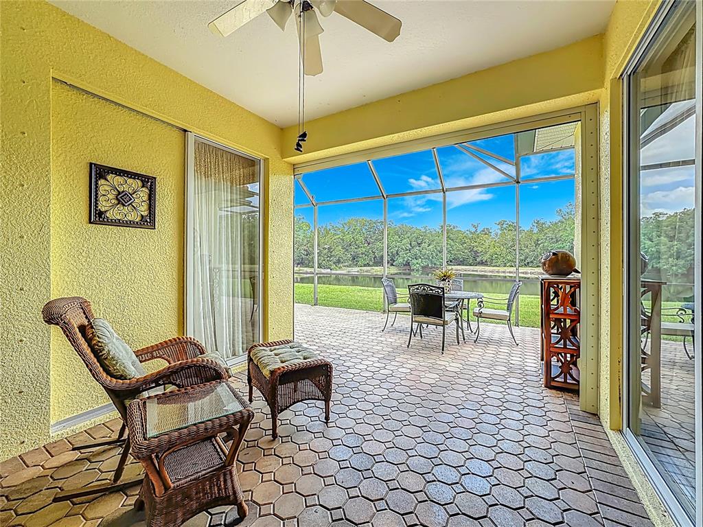 8721 Stone Harbour Loop Bradenton, FL 34212 - Photo 2 of 71 a view of a patio with a table chairs and a backyard