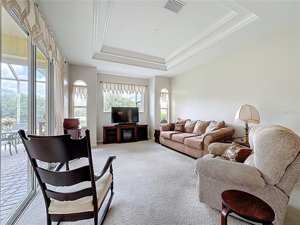8721 Stone Harbour Loop Bradenton, FL 34212 - Photo 22 of 71 a living room with furniture and a large window