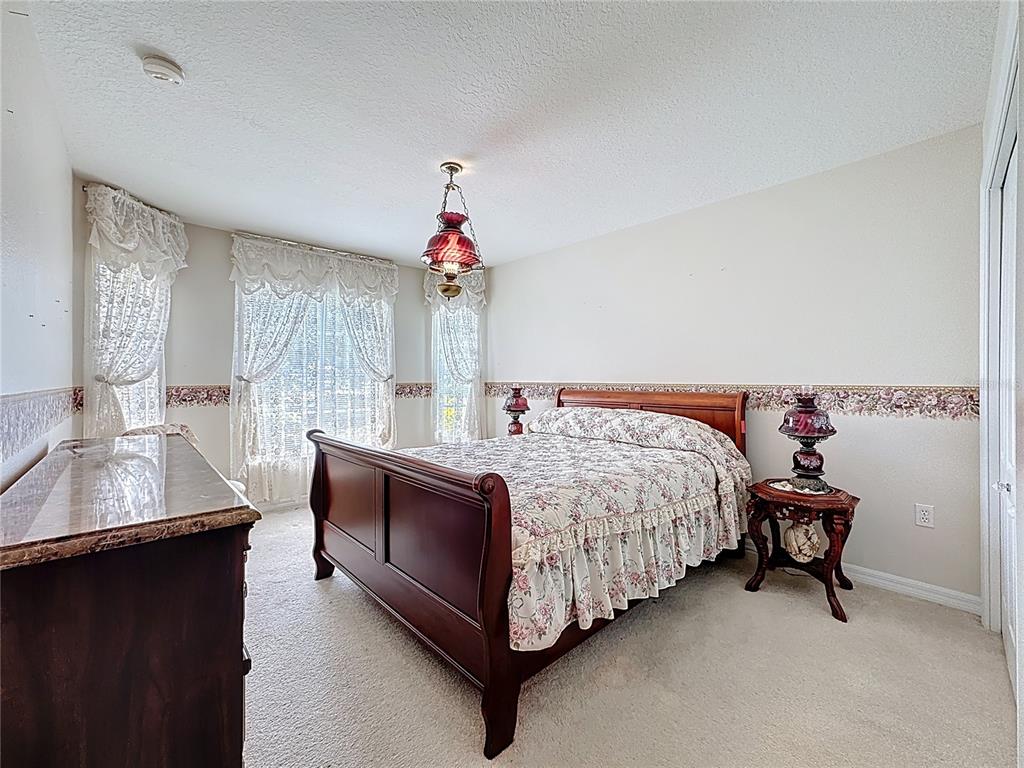 8721 Stone Harbour Loop Bradenton, FL 34212 - Photo 28 of 71 a bed room with a bed and a couch