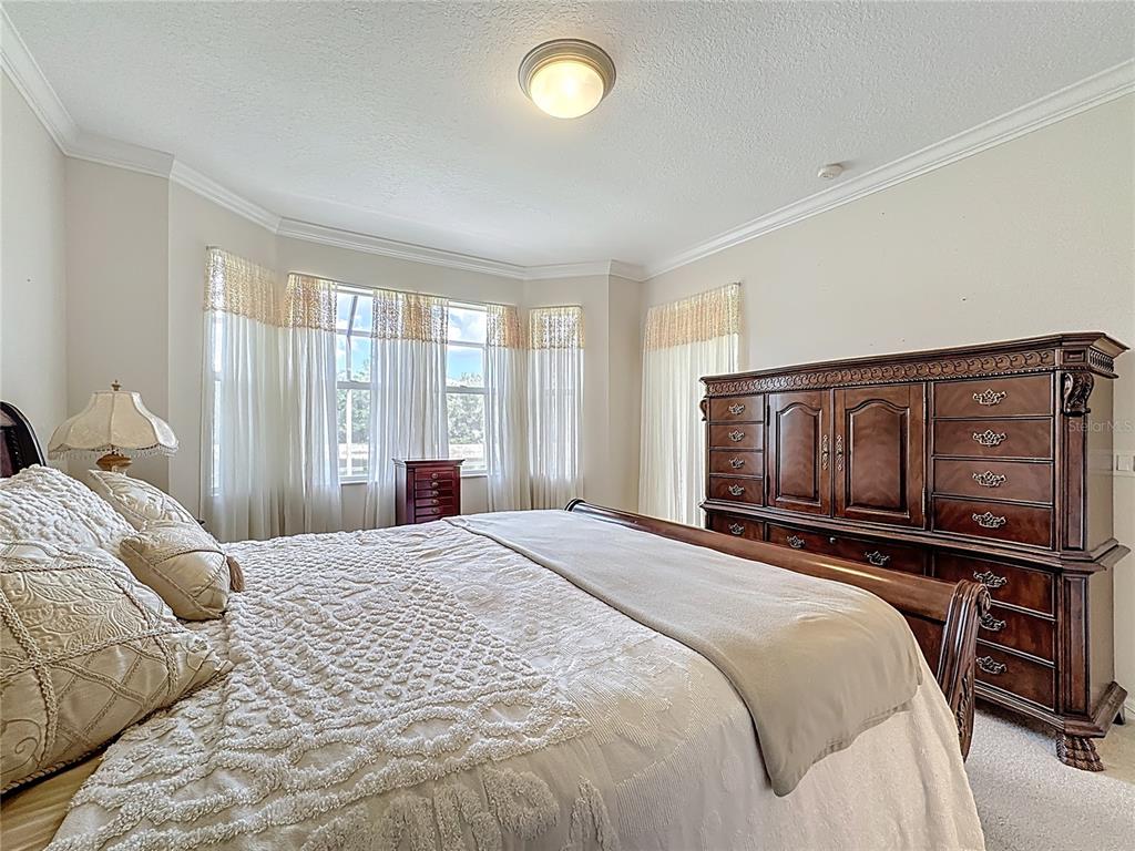 8721 Stone Harbour Loop Bradenton, FL 34212 - Photo 33 of 71 a bedroom with a bed and wooden floor