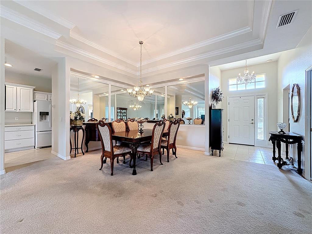 8721 Stone Harbour Loop Bradenton, FL 34212 - Photo 8 of 71 a view of a dining area with furniture and a chandelier