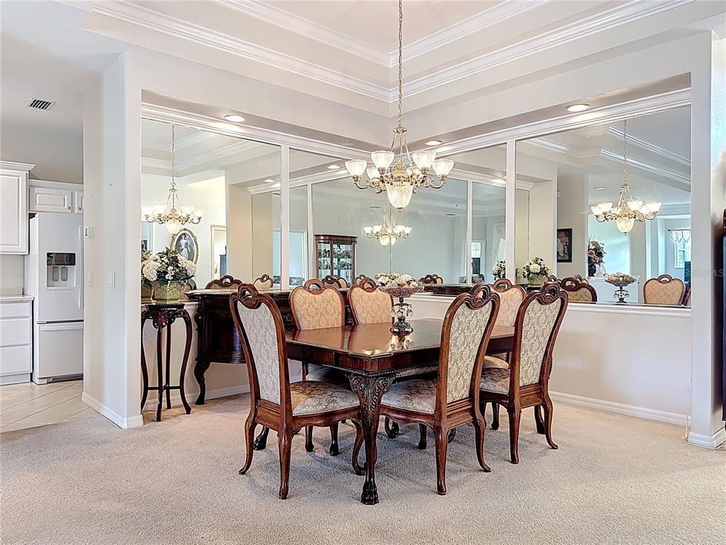 8721 Stone Harbour Loop Bradenton, FL 34212 - Photo 9 of 71 a dining room with furniture and a chandelier