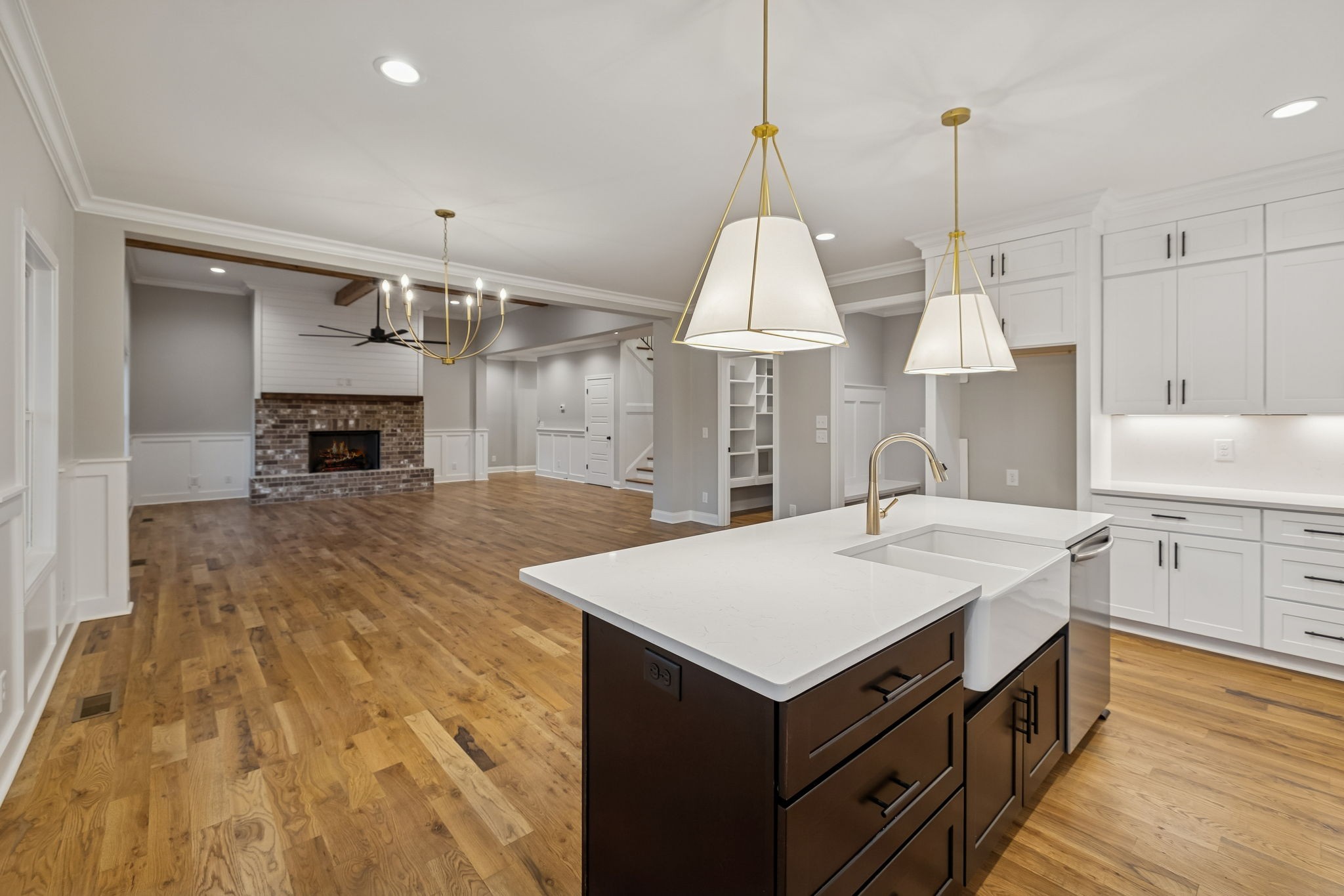 13645 Cainsville Road Lebanon, TN 37090 - Photo 16 of 60 a large kitchen with kitchen island a stove a sink a center island and a wooden floor