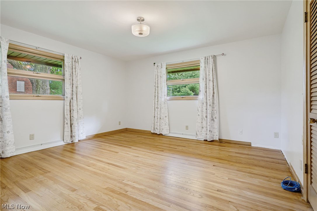 1010 Knollwood Road Northwest Canton, OH 44708 - Photo 21 of 47 Unfurnished room featuring plenty of natural light and light wood-type flooring