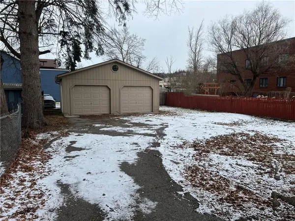 a house with a yard covered with snow in front of house
