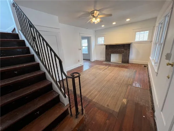 wooden floor in an empty room with a fireplace