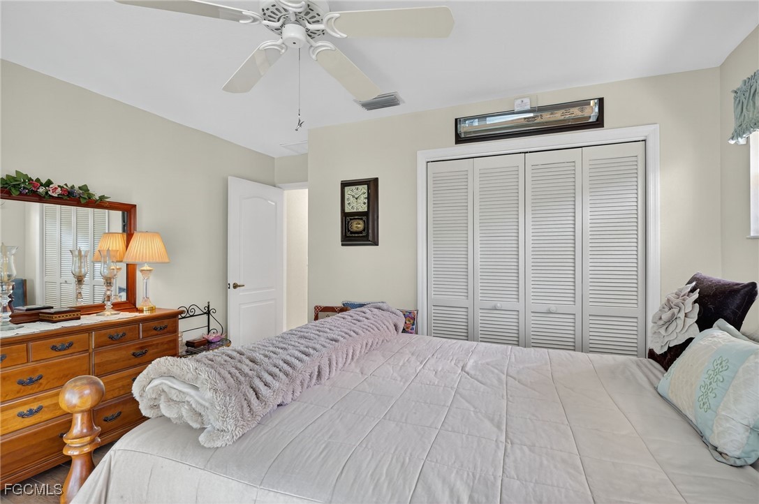 4306 Southwest 3rd Avenue Cape Coral, FL 33914 - Photo 20 of 50 a bedroom with a bed and a chandelier
