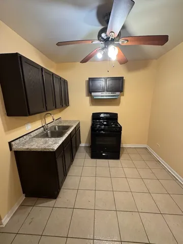 a kitchen with stainless steel appliances a stove a sink and a refrigerator