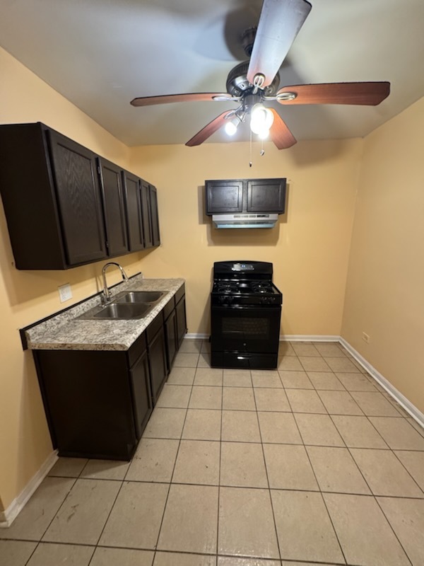 2908 West Fillmore Street, Unit 2 Chicago, IL 60612 - Photo 2 of 7 a kitchen with stainless steel appliances a stove a sink and a refrigerator