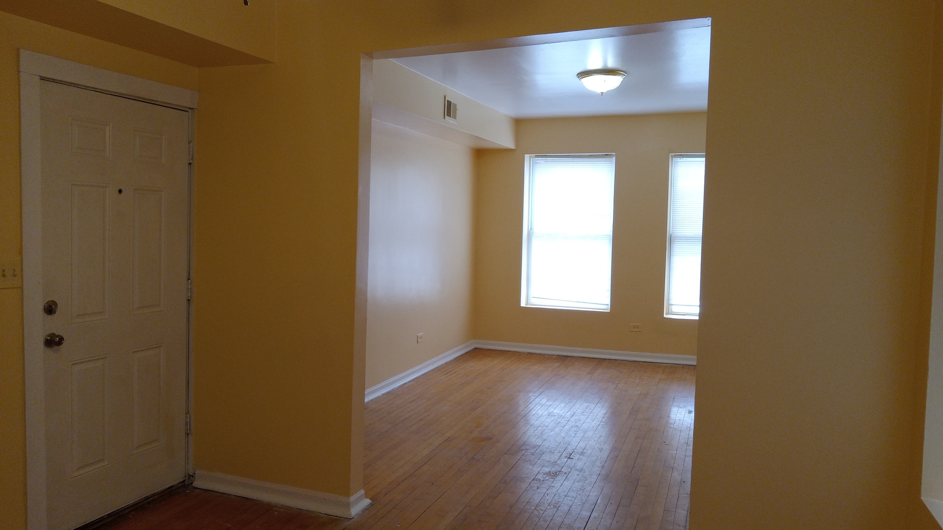 2908 West Fillmore Street, Unit 2 Chicago, IL 60612 - Photo 6 of 7 a view of empty room with wooden floor and fan