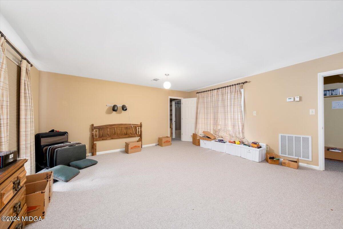 5157 Zebulon Road Macon, GA 31210 - Photo 19 of 34 a bed room with furniture and a fireplace