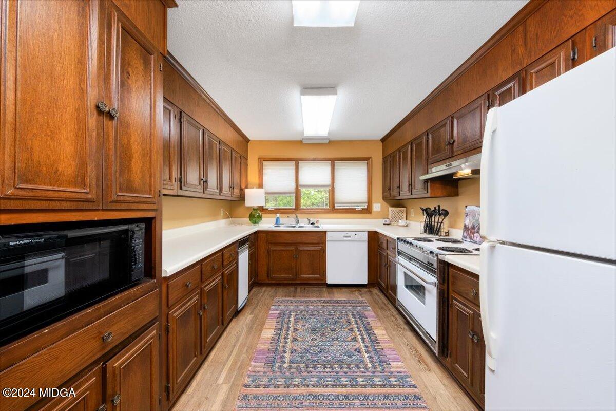 5157 Zebulon Road Macon, GA 31210 - Photo 2 of 34 a large kitchen with stainless steel appliances granite countertop a stove a sink dishwasher and a refrigerator