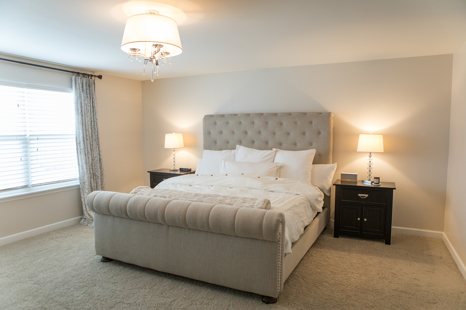 5718 Oak Ridge Way Lisle, IL 60532 - Photo 13 of 29 a bedroom with a bed and a chandelier