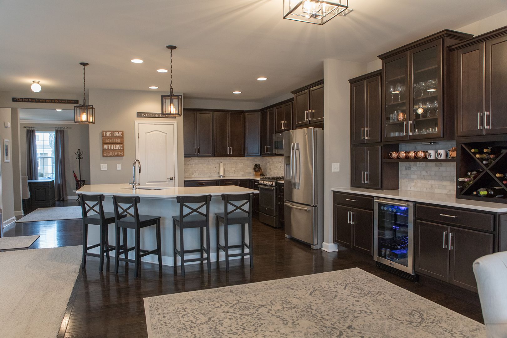 5718 Oak Ridge Way Lisle, IL 60532 - Photo 8 of 29 a kitchen with stainless steel appliances granite countertop a table chairs sink refrigerator and cabinets