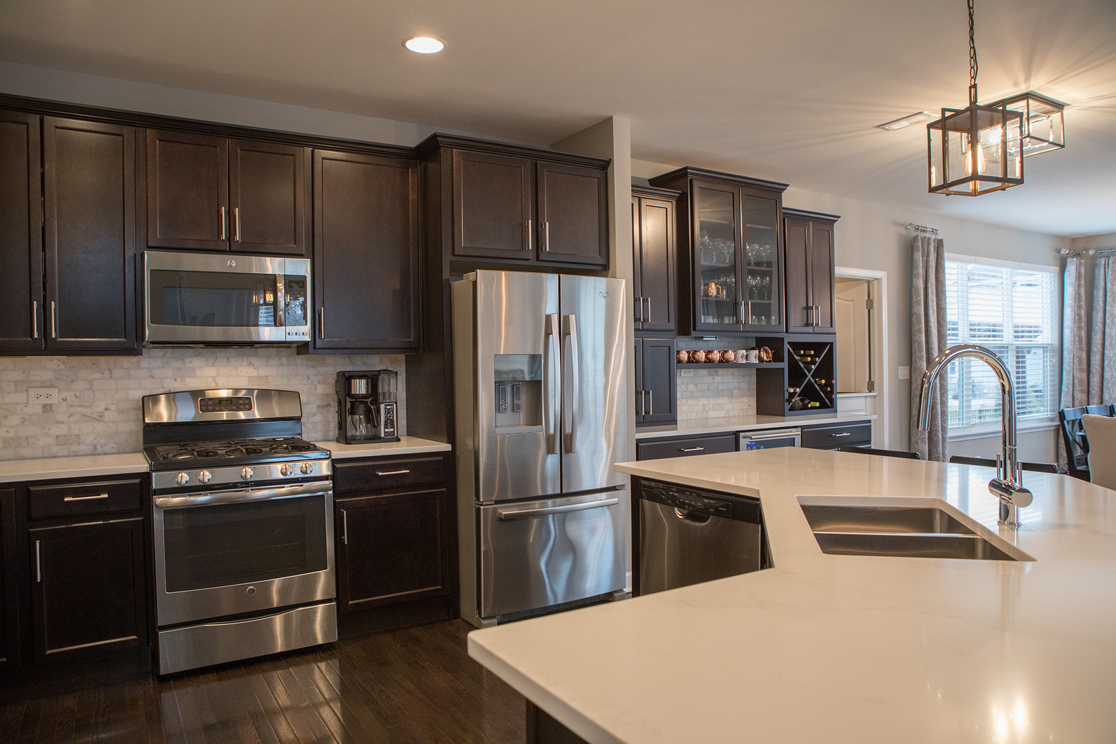 5718 Oak Ridge Way Lisle, IL 60532 - Photo 9 of 29 a kitchen with granite countertop a refrigerator stove and microwave
