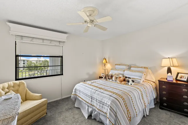 a bedroom with a bed couches and window