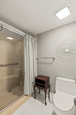 a bathroom with a toilet a sink and shower