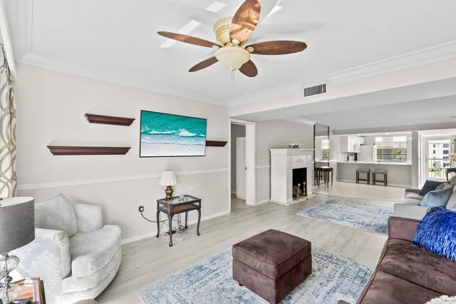 a living room with furniture fireplace and window