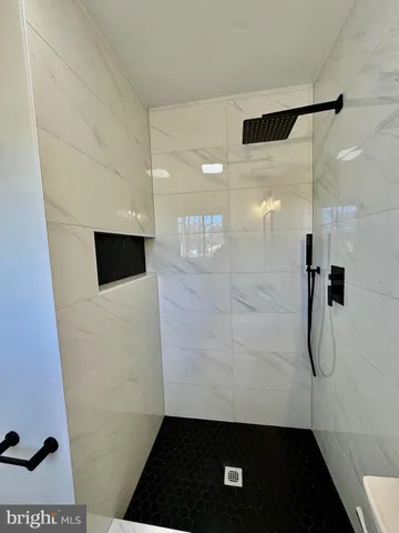 a bathroom with a toilet sink vanity and mirror