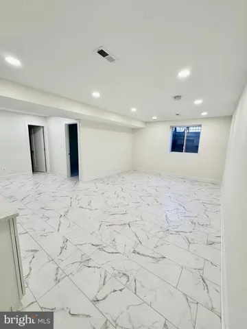 a large white kitchen with a sink and cabinets