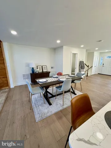 a living room with furniture a wooden floor and next to a window