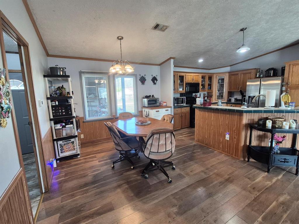 438 Silver River Road Gholson, TX 76705 - Photo 14 of 39 a view of a dining room with furniture window and wooden floor