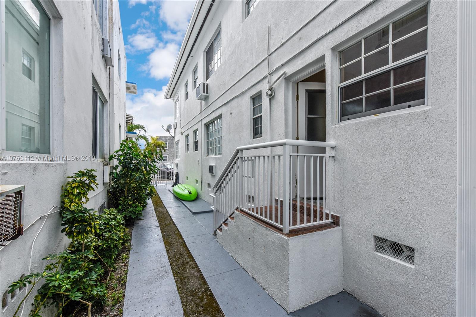 330 74th Street, Unit 7 Miami Beach, FL 33141 - Photo 13 of 27 a view of balcony with a potted plant and stairs