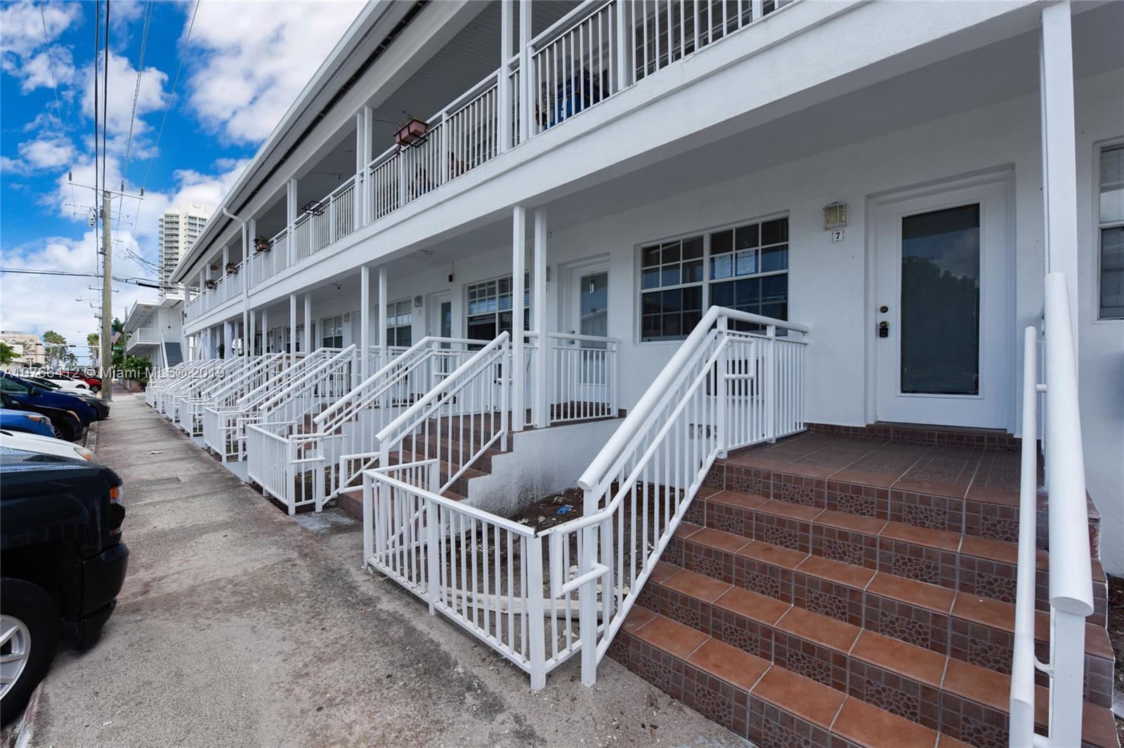 330 74th Street, Unit 7 Miami Beach, FL 33141 - Photo 2 of 27 a view of a house with wooden deck