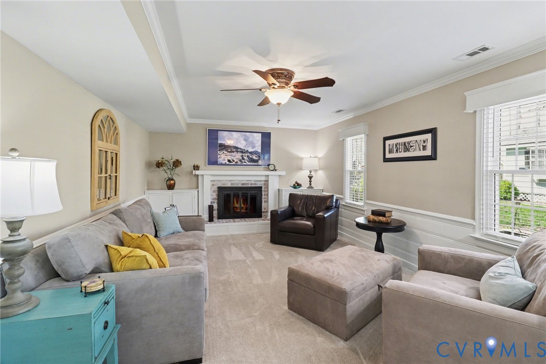 548 Glenmeadow Road Midlothian, VA 23114 - Photo 5 of 31 a living room with furniture a fireplace and a window