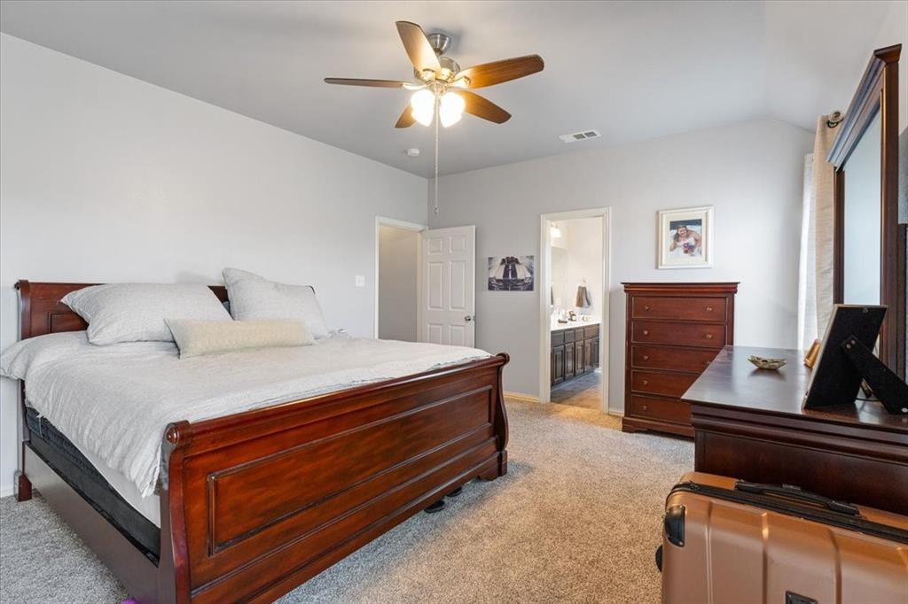 5366 Tree Grace Lane Kaufman, TX 75142 - Photo 14 of 33 a bedroom with bed and a chandelier